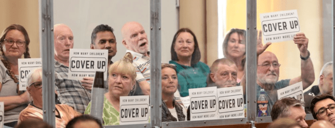 Raja Miah and The Rabble holding upCover-Up flyers at OMBC meeting