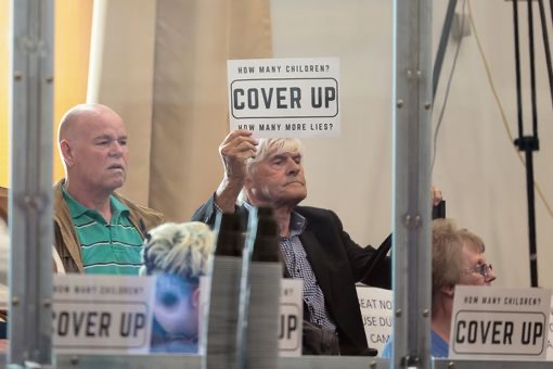 Wazza Warren Bates holding up cover up card at EM